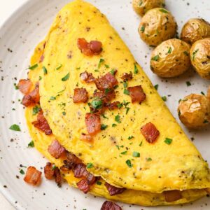 OMLETTE (PEPPERS, ONIONS, TOMATOES, CHEESE) W/ SIDE OF BACON AND HOME FIRES